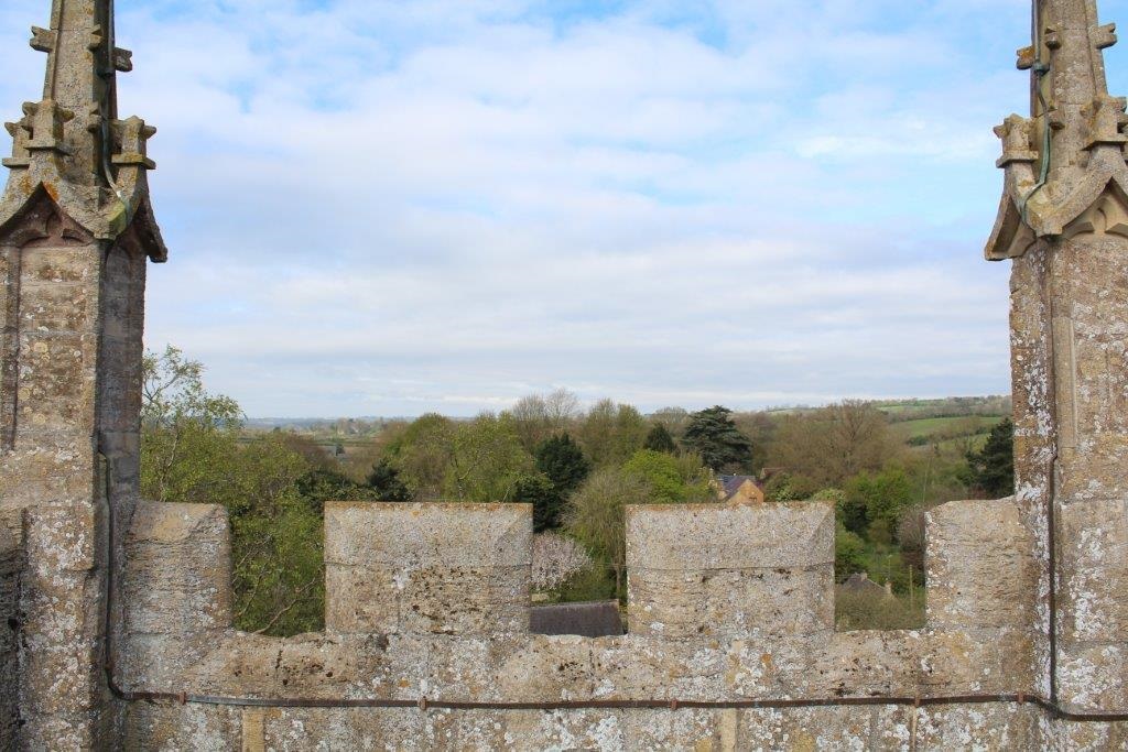 Photograph of horizon, and some stone crenellations in foreground
