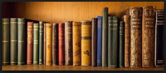 A photograph of hard-back books on a bookshelf.